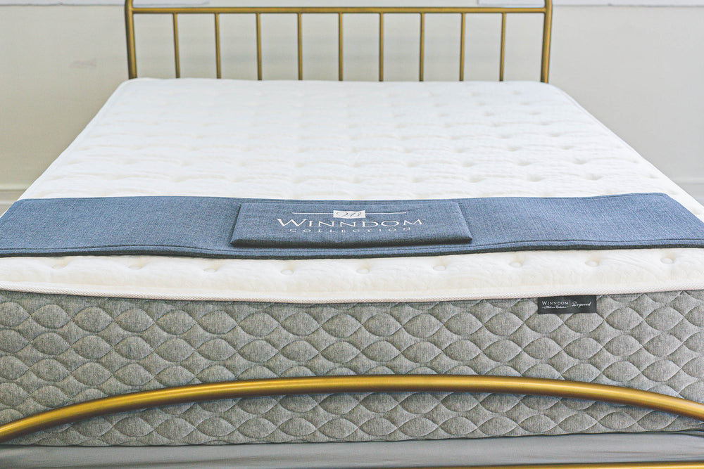 WInndom Dogwood mattress shown from the foot of the bed with a brass bed. FIrm mattress, innerspring mattress, foam mattress