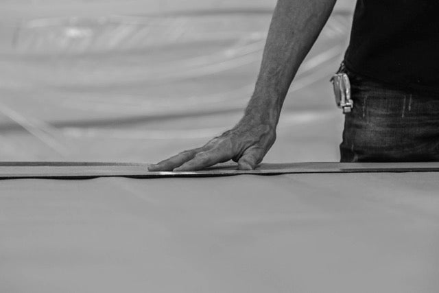 Man with his hand on mattress materials