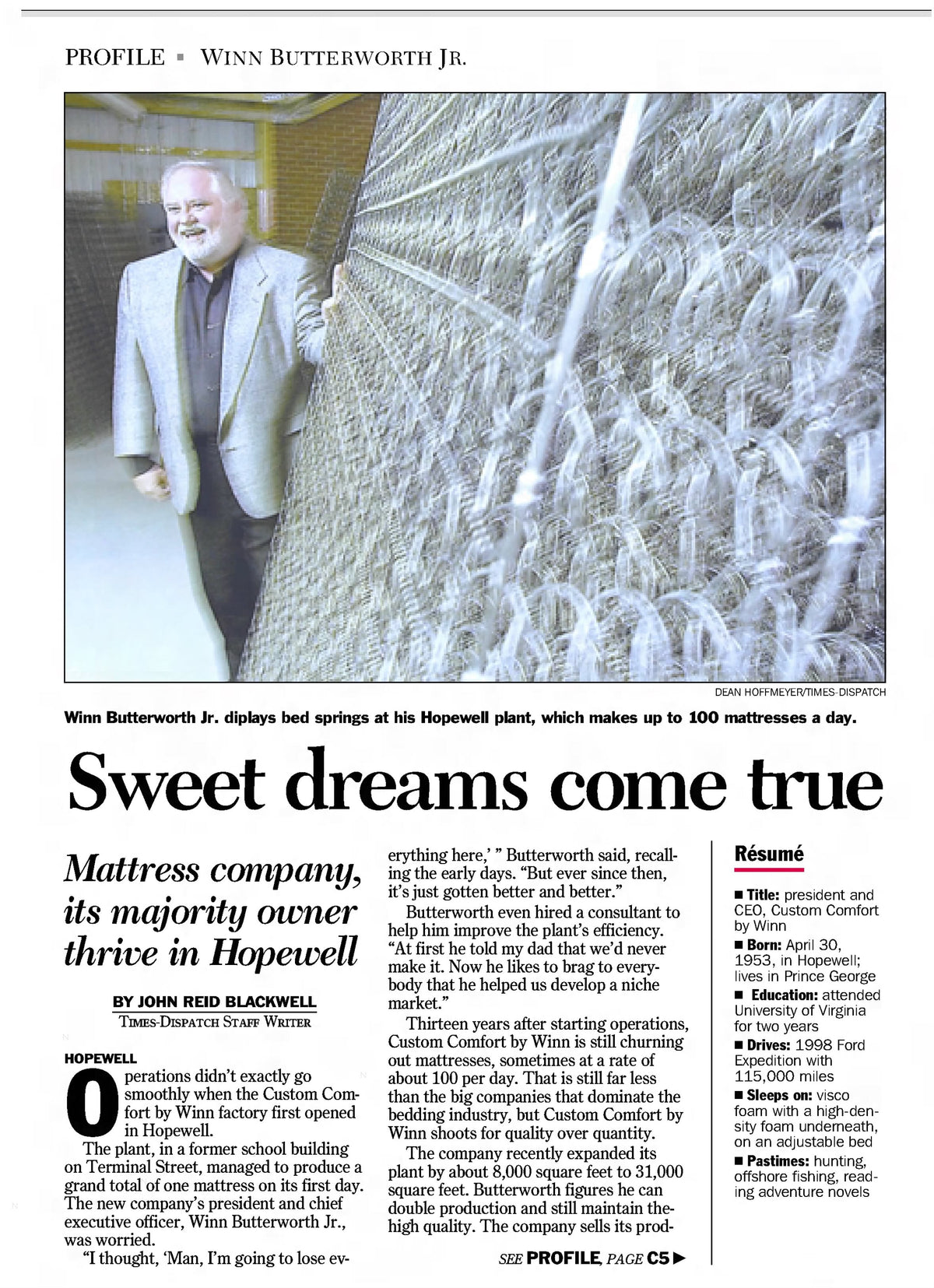 Newspaper article featuring Winn Butterworth in a suit standing next to a mattress production line with the headline 'Sweet dreams come true'.