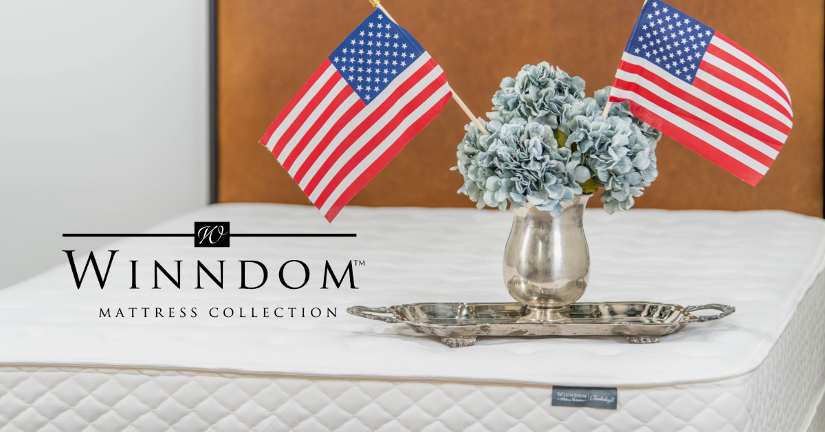 Winndom mattress collection with American flags and a decorative vase on a bed.