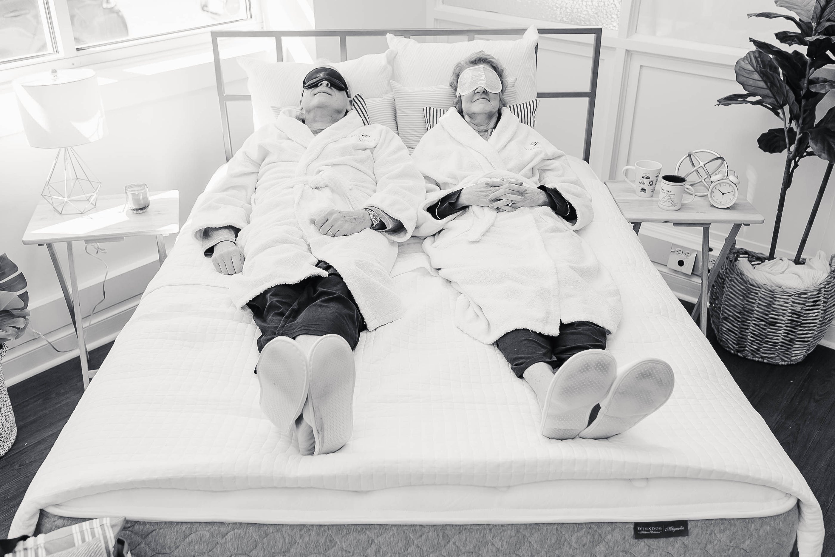 A couple sleeping on a Winndom mattress with eye masks on.  Winndom mattress, Magnolia Winndom Mattress