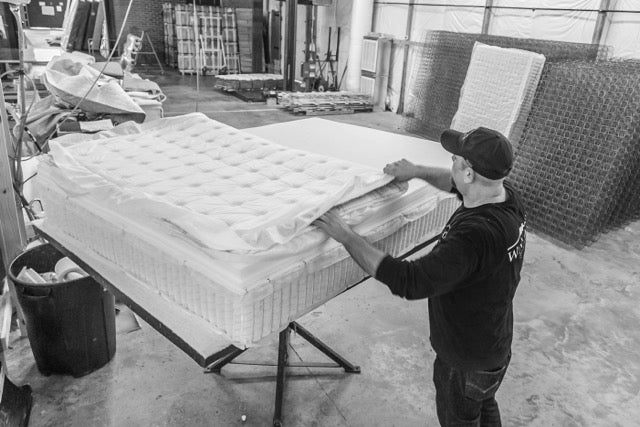 Winndom mattress being assembled in our factory showing the layers of foam. Innerspring mattress, foam mattress, American made mattress. Hopewell Virginia