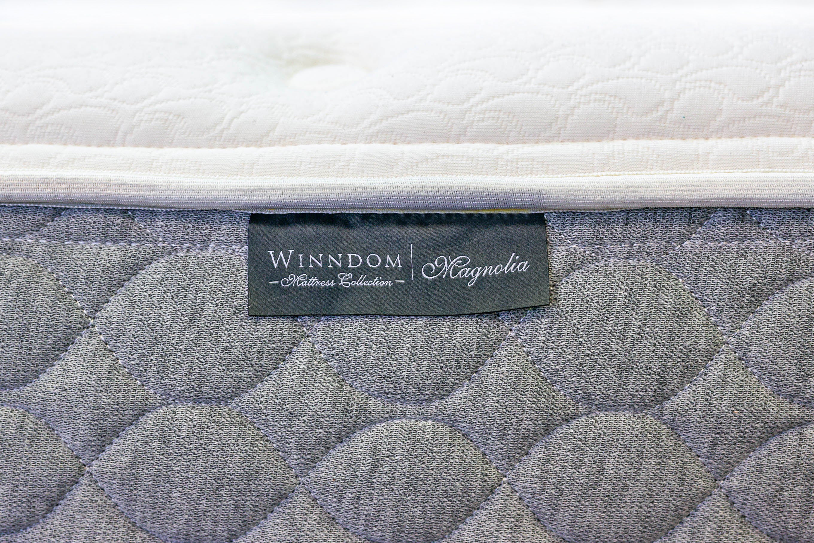 close up image of a mattress label Winndom Mattress Collection - Magnolia