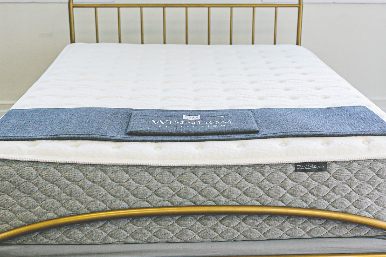 WInndom Dogwood mattress shown from the foot of the bed with a brass bed. FIrm mattress, innerspring mattress, foam mattress