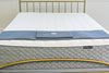 WInndom Dogwood mattress shown from the foot of the bed with a brass bed. FIrm mattress, innerspring mattress, foam mattress